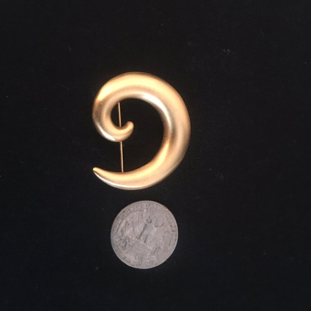 Beautiful gold crescent pin.